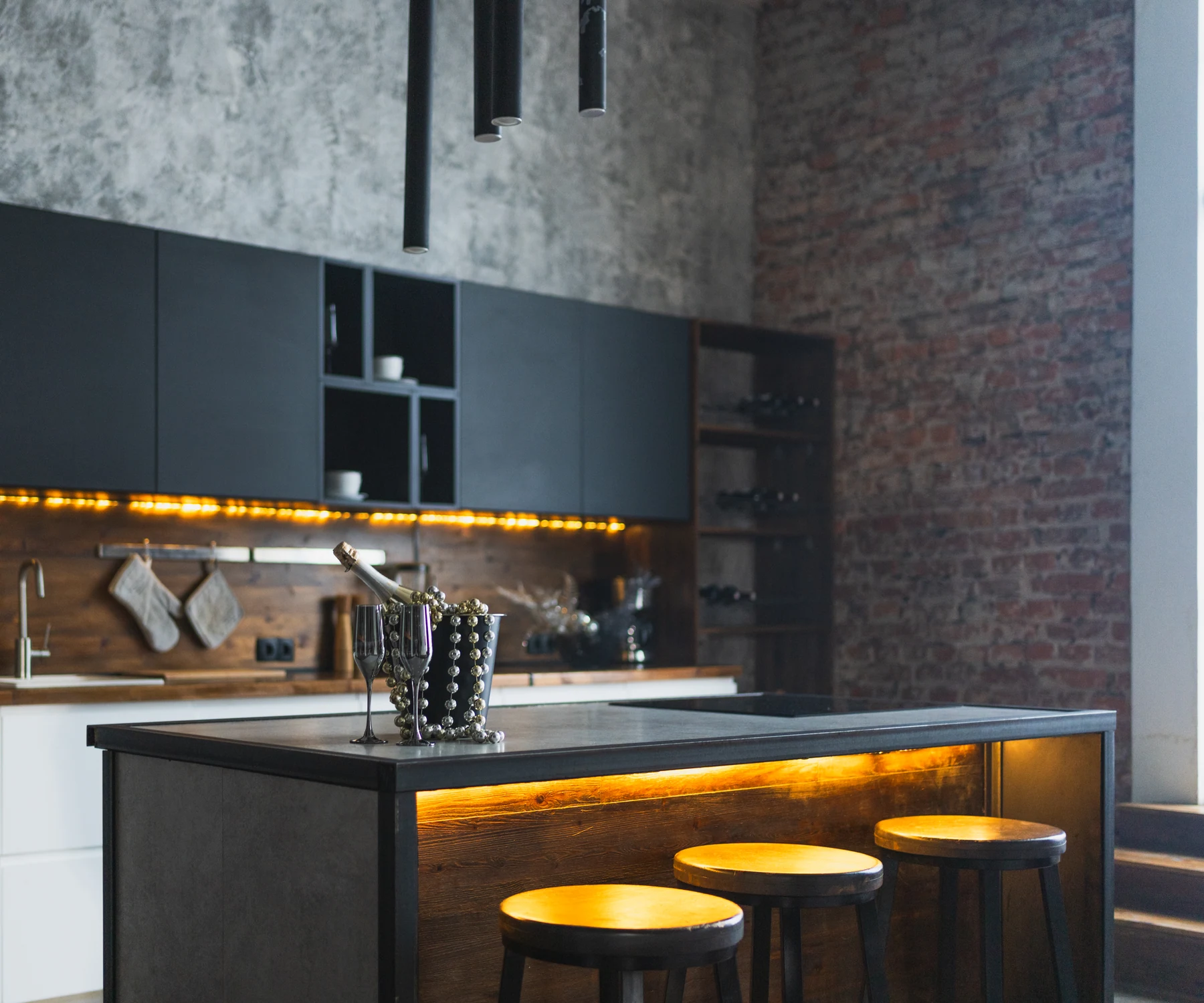 Dark modern kitchen with warm architectural lighting
